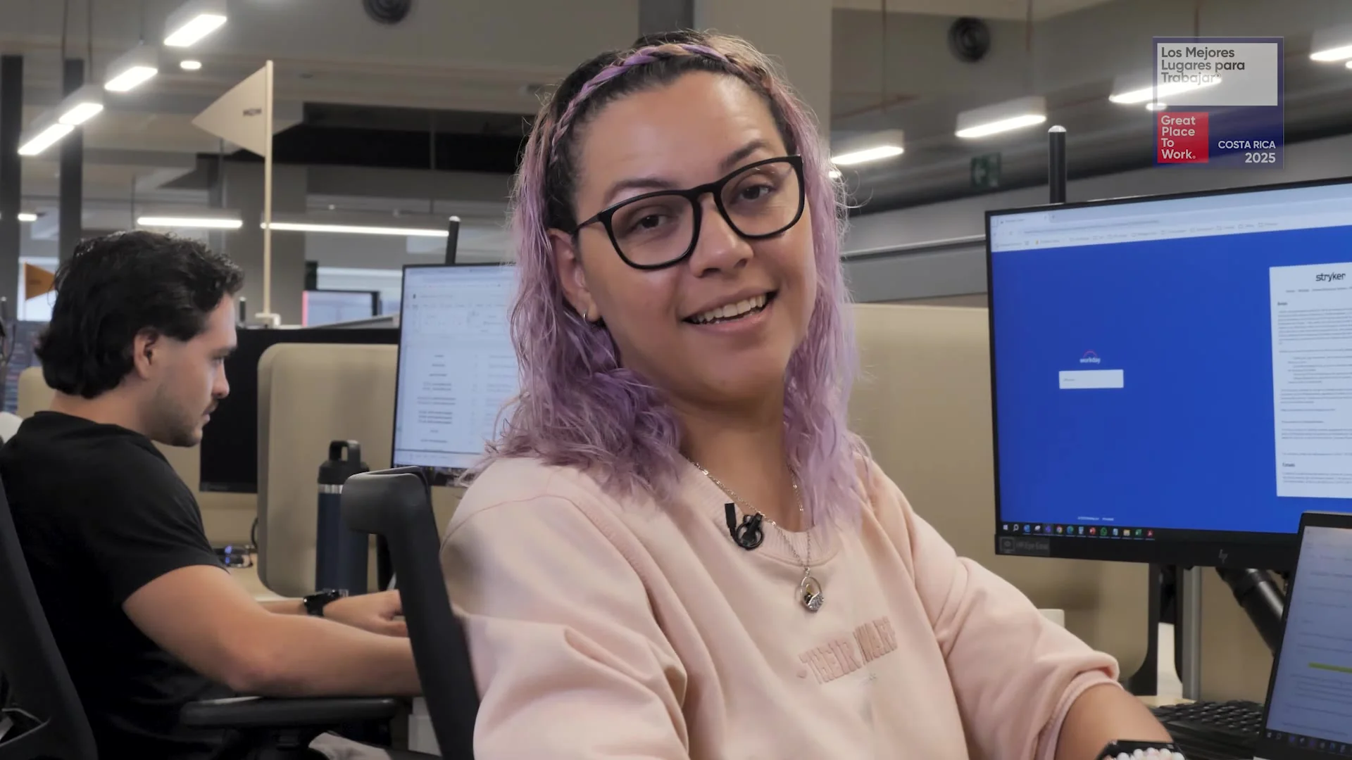 Colaboradora de Stryker sonriendo durante la grabación de su frase en la oficina
